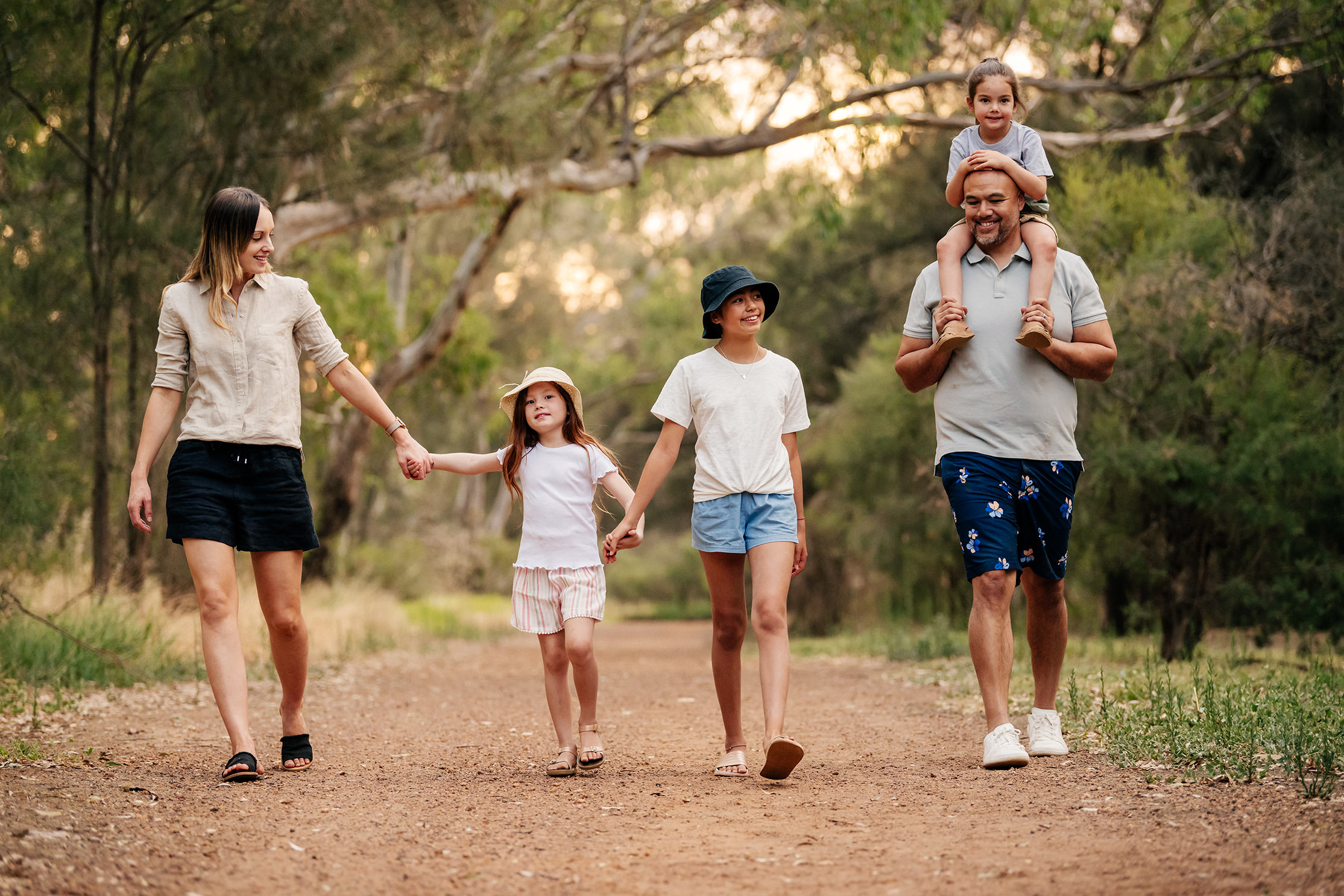 a family walking by the trail in a park in rivermark