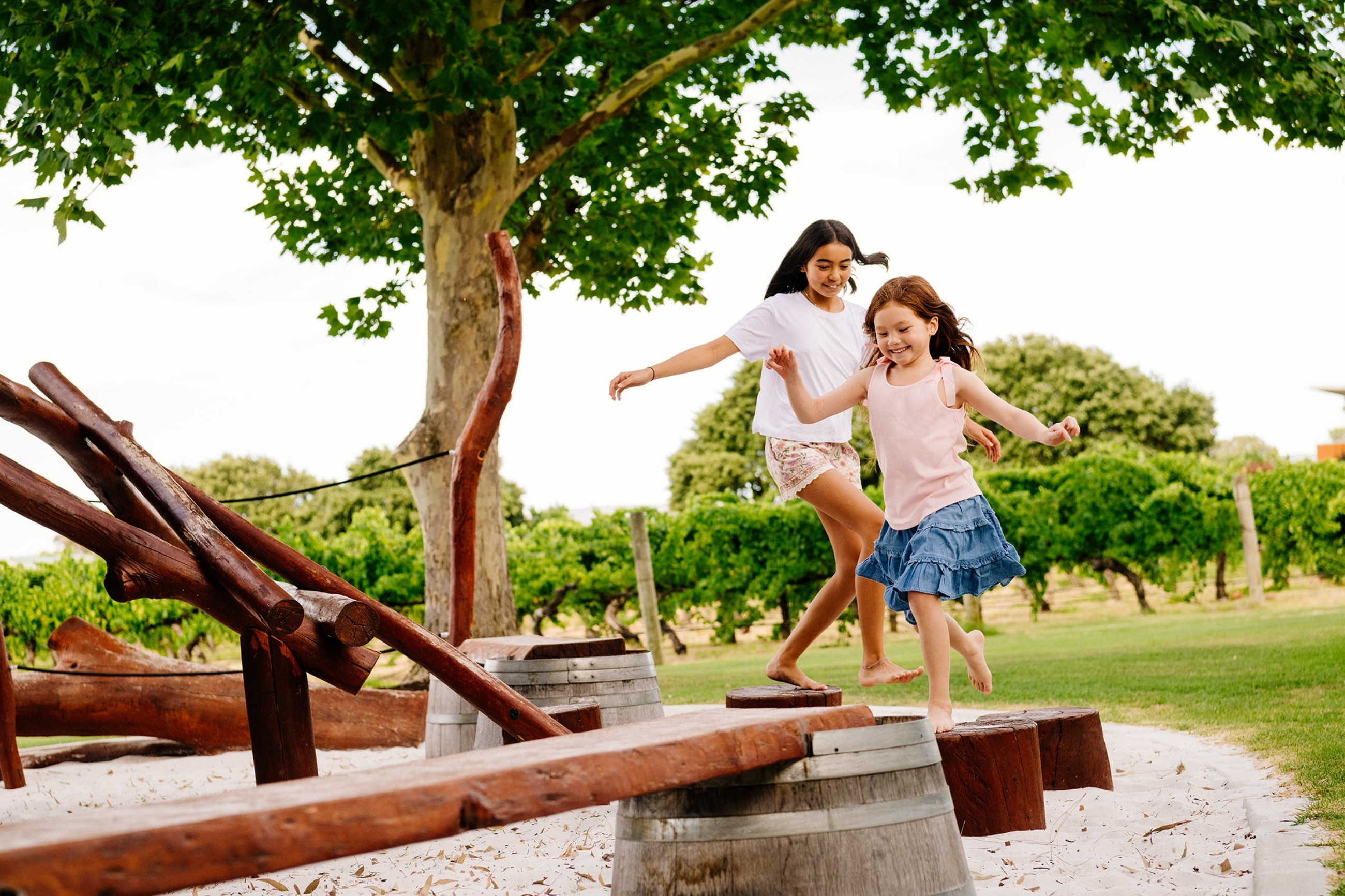 Two Happy Children Playing On Nature Playground