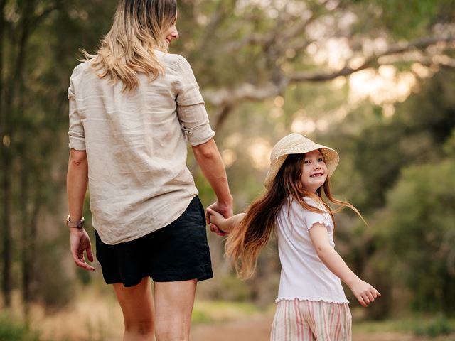 mother and daughter walking through a trail in a park in rivermark